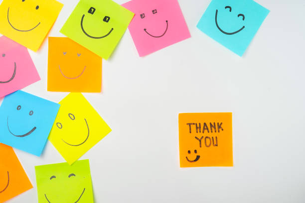 istock Thank you and smile icon inspirational handwriting on sticky notes on hand held 2168016672
