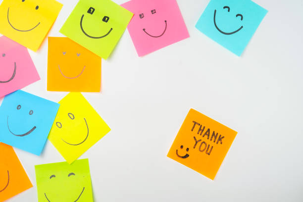 istock Thank you and smile icon inspirational handwriting on sticky notes on hand held 2168016678
