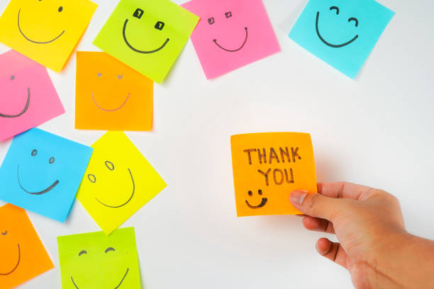 istock Thank you and smile icon inspirational handwriting on sticky notes on hand held 2168016712