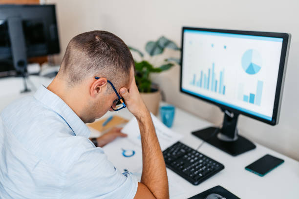 istock Tired Mid-Adult Man Working On A Computer At The Office 2168016754