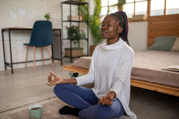 istock Young woman meditating at home 2168019941