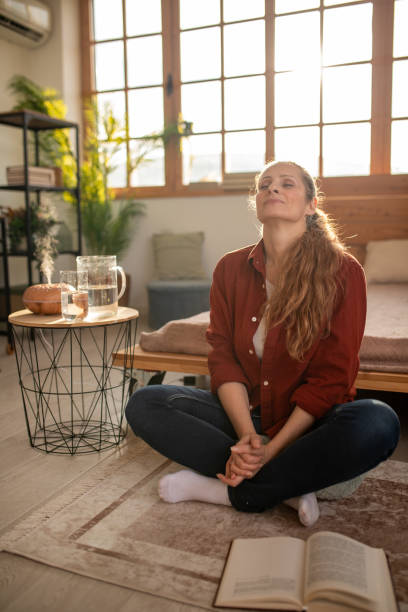 istock Woman meditating at home 2168020135