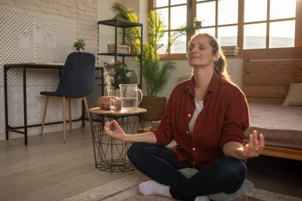 istock Woman meditating at home 2168020181