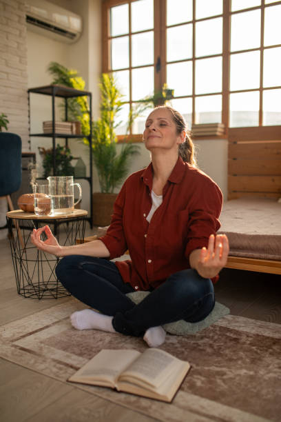 istock Woman meditating at home 2168020220