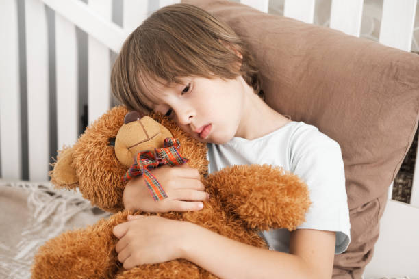 istock The little boy is sad and hugs the bear. 2168023967