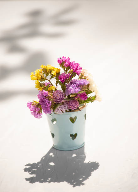 the vase stands on tiles against an almost perfect black background