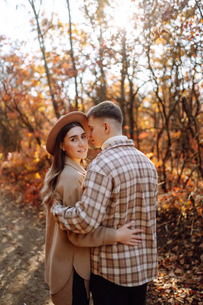 istock A young couple enjoying a romantic walk in the autumn forest. 2168025621
