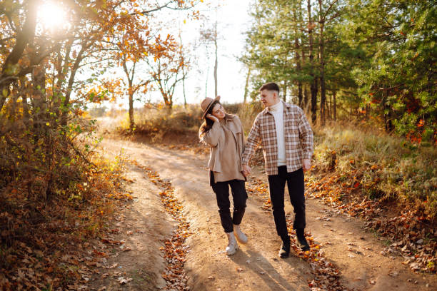 istock A young couple enjoying a romantic walk in the autumn forest. 2168025651