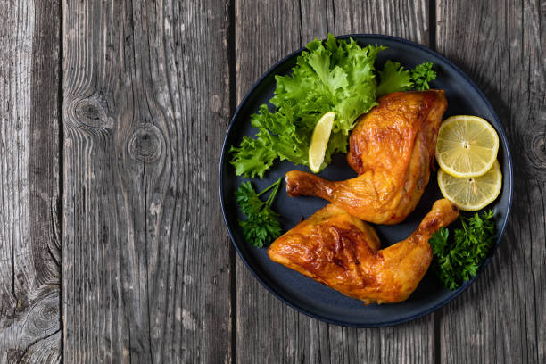 istock fried chicken legs with lettuce, lemon on plate 2168027253