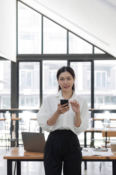 istock Confident Young Female Office Worker Discussing Work Over the Phone in a Modern Office Setting 2168027358