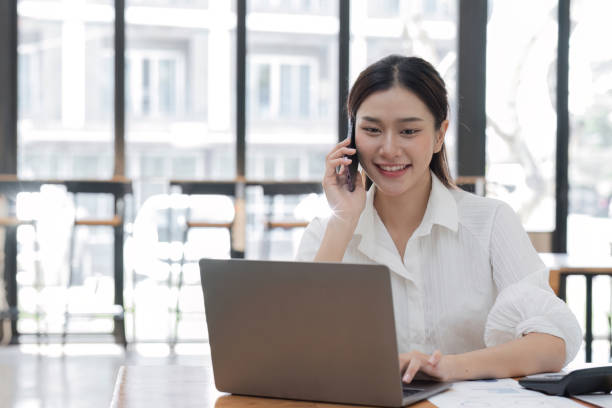 istock Confident Young Female Office Worker Discussing Work Over the Phone in a Modern Office Setting 2168027389