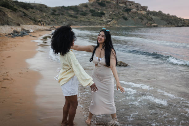 istock Best Friends Smiling and Hugging at the Beach 2168031205