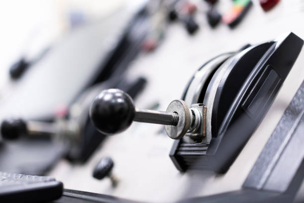 Close-up of the lever on the electronic control panel, blurred light background