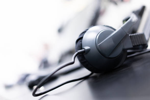 istock Black headphones with microphone, electronic communication device, selective focus, on blurred light background 2168031601