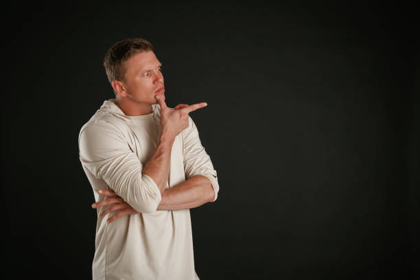 istock New product, showing at copy space. Man is against background in the studio 2168031731