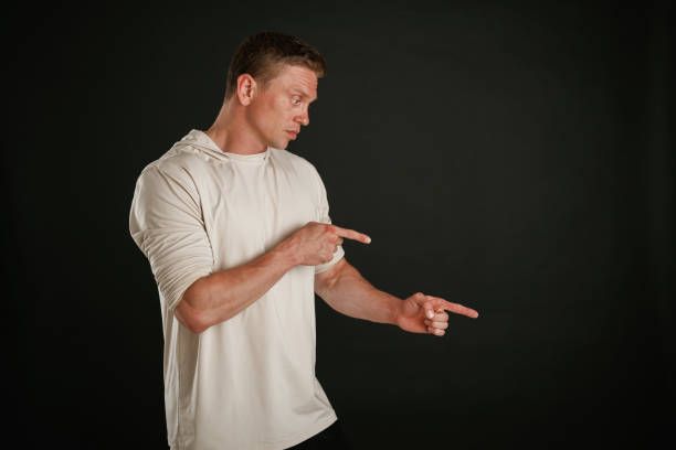 istock New product, showing at copy space. Man is against background in the studio 2168031770