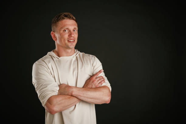 istock Posing, arms crossed. Man is against background in the studio 2168031915