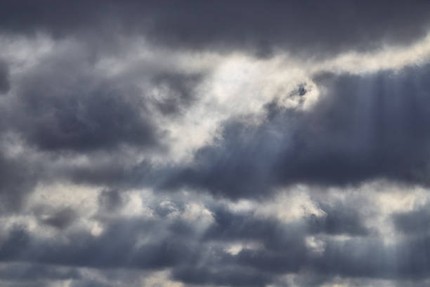 istock Light breaks through the rain clouds in the sky, light passes through the clouds, 2168031991