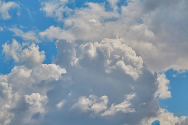 White clouds against a clear blue sky close-up.