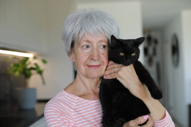 istock Senior woman and her black cat 2168032070