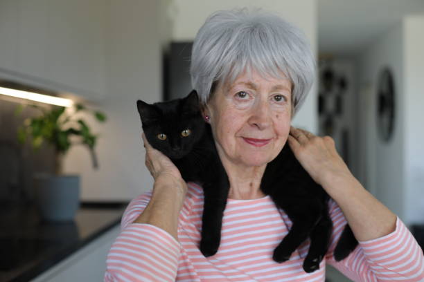 istock Senior woman and her black cat 2168032071