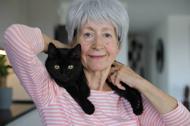 istock Senior woman and her black cat 2168032121