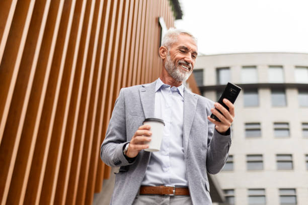 istock Mature Businessman with Coffee and Smartphone 2168039694