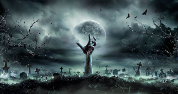 istock Zombie Hand Rising Out Of A GraveYard - Halloween 2168040176