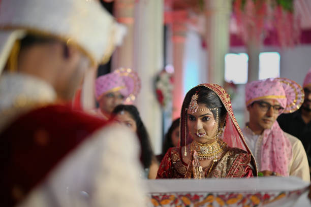istock Indian Bride standing during Mangala Ashtaka ritual behind Wedding Curtain 2168044027