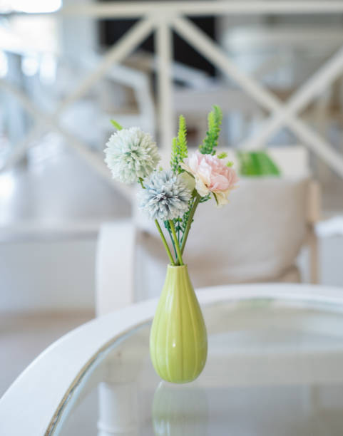 istock Fake flowers in a vase on table 2168045606