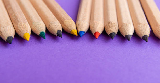istock Colored multi-colored pencils on a purple background. Banner image. 2168045724