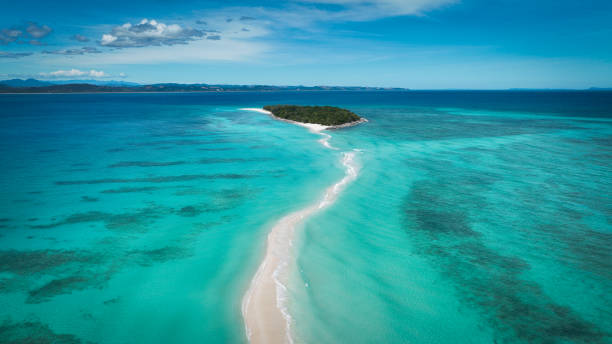 Aerial view of Nosy Iranja Island showcasing pristine waters and sandbars in Madagascar during bright daylight An aerial view highlights the stunning turquoise waters surrounding Nosy Iranja Island, revealing captivating sandbars that stretch across the ocean, inviting exploration. madagascar beach photos stock pictures, royalty-free photos & images