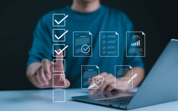istock Digital form checklist, Online survey concept. Person interacts with digital form checklist on laptop with process of filling out online survey and completing digital forms with checkbox and document. 2168048357
