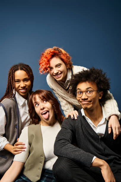Multicultural college students enjoying a creative studio session with their queer friend