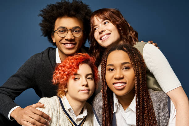 istock College students celebrate friendship in a creative studio with a blue backdrop 2168048916