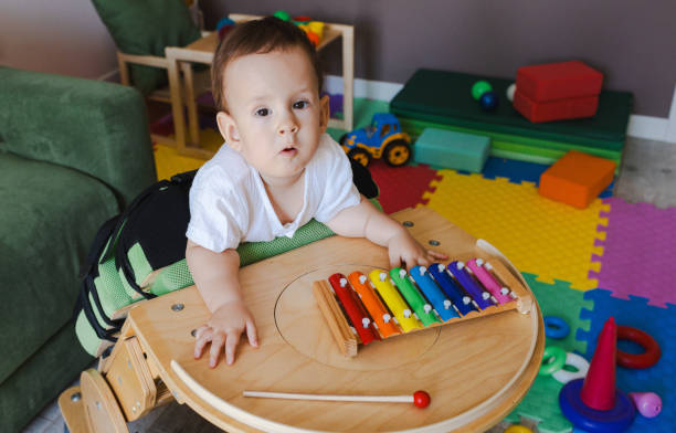 istock Little boy with neurodevelopmental disorders participates in music therapy using a xylophone, promoting his physical rehabilitation in a colorful playroom 2168049223
