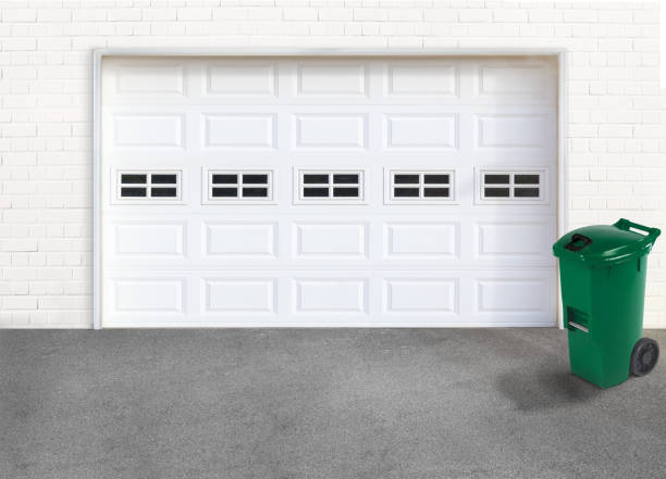 istock Green garbage bin in-front of the garage door 2168050092