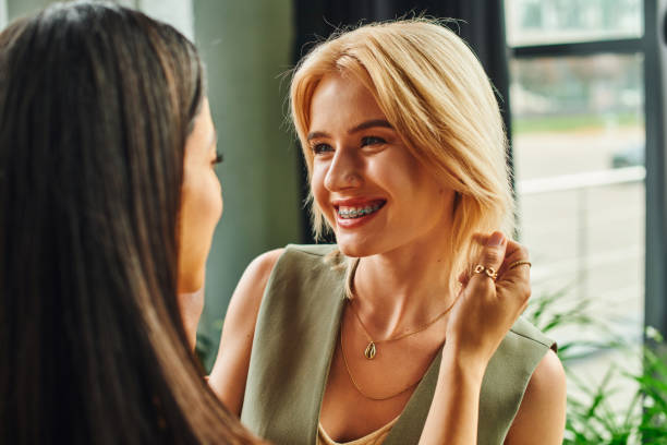 istock Multicultural businesswomen having tender moment in a modern office setting 2168050135