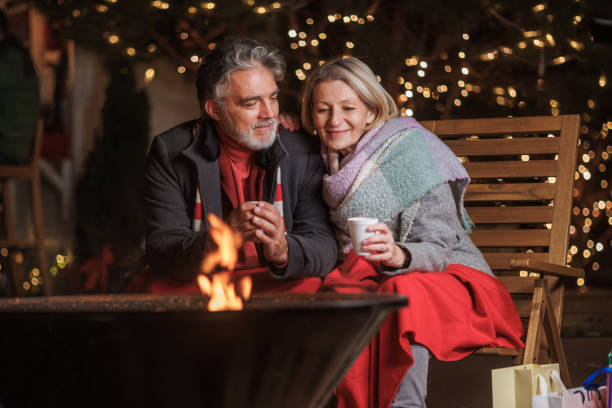istock Happy couple enjoying a cozy winter night by the fire 2168051231