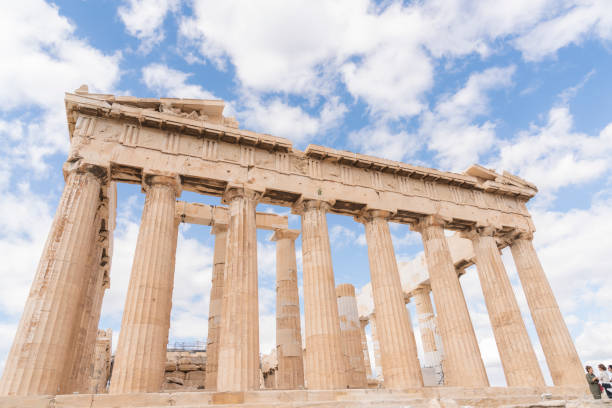 View of Acropolis and Parthenon The Parthenon on the Athenian Acropolis, Sun shining through the columns. The Temple is dedicated to the Greek Goddess Athena. Athens, Greece.