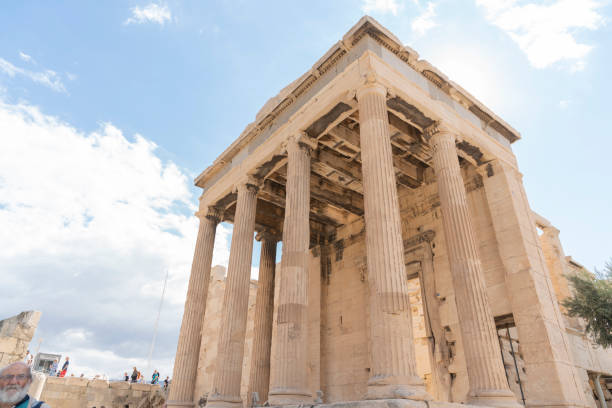 View of Acropolis and Parthenon The Parthenon on the Athenian Acropolis, Sun shining through the columns. The Temple is dedicated to the Greek Goddess Athena. Athens, Greece.