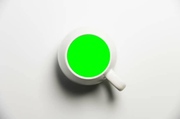 An empty cup of coffee stands on the table, on a white background with a clipping path, top view, flat lay.