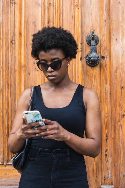 istock Black woman chatting on smartphone 2168055422