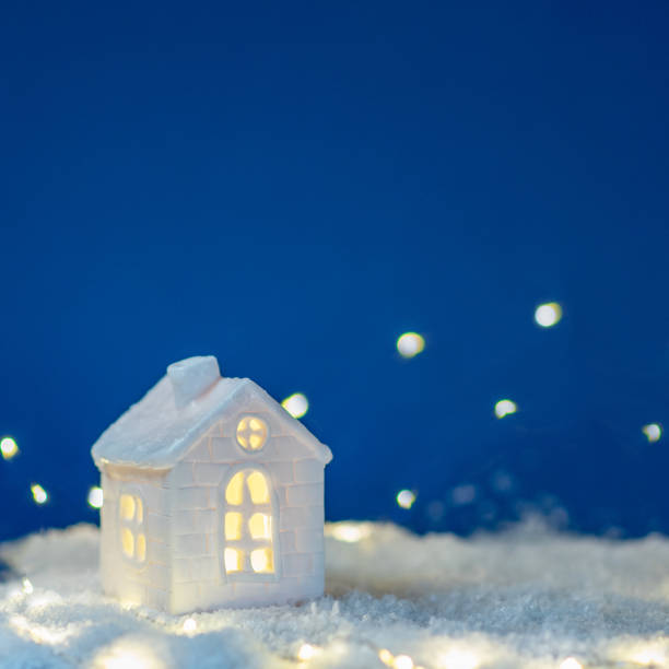 istock house with snow and decoration x-tree background blue 2168055927