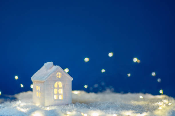 istock house with snow and decoration x-tree background blue 2168056301