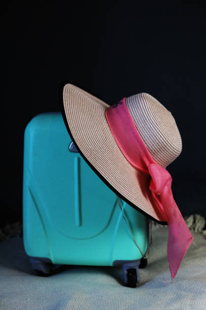istock pack a suitcase for a summer vacation, taking with them a hat, a book, glasses 2168058823
