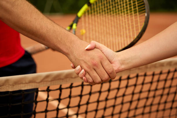 istock Tennis players shaking hands at net 2168059720