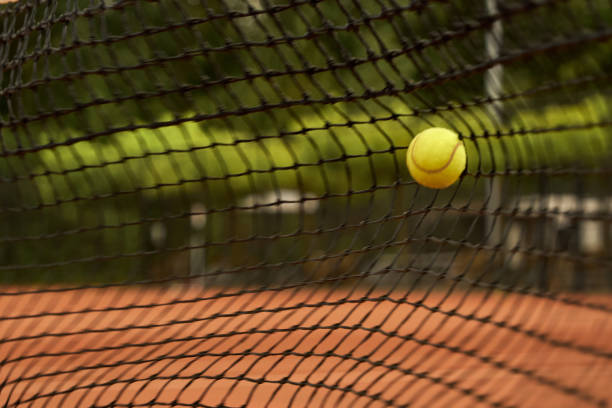 tennis ball is hitting a net