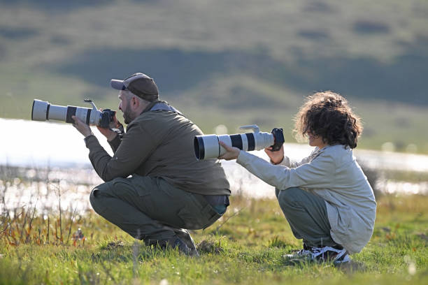 istock Man and child taking photos in nature. 2168060319