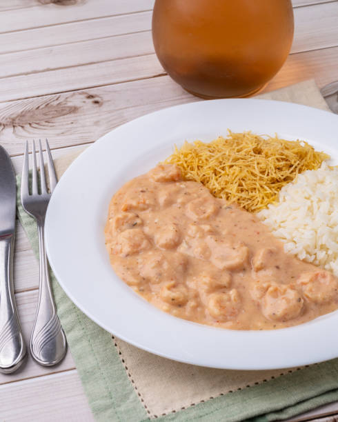 istock Shrimp strogonoff with rice and straw potato over wooden table 2168061304